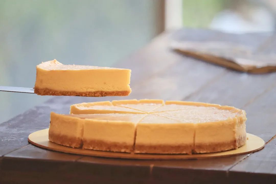 Cheesecake or Honey Chilly Potato. Alt: Editorial cheesecake plating — single-source soft light, P2V Labs Ahmedabad.